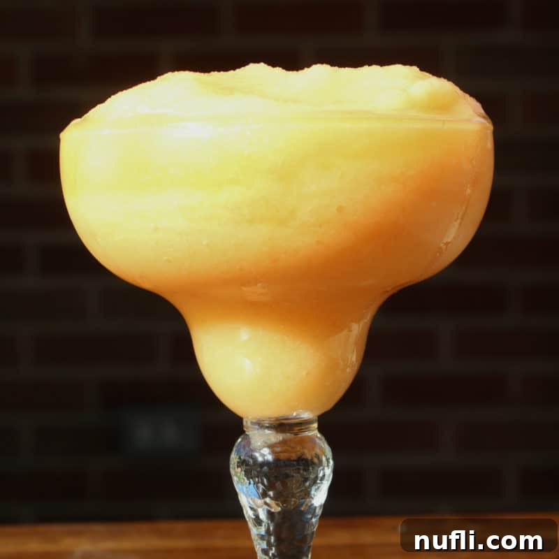 Frozen Peach Daiquiri in a margarita glass