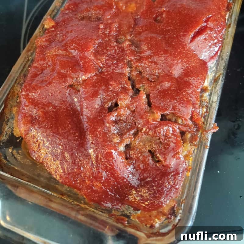 A savory Stove Top Meatloaf, perfectly baked in a glass dish, ready to be sliced and served as a classic comfort food dinner.
