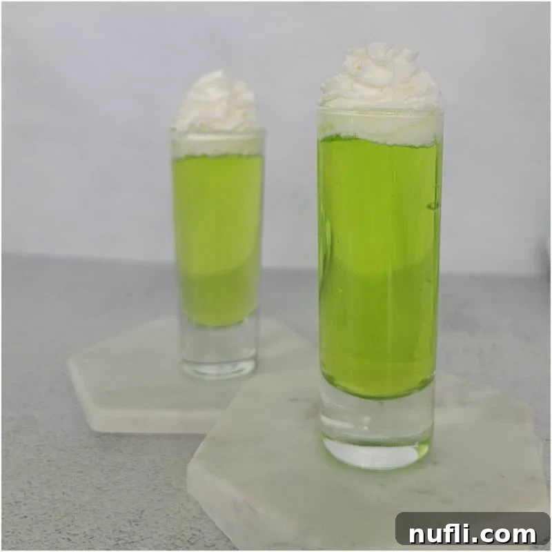 Tropical Pineapple Cocktails Made Easy 20 two bright green Scooby Snack Shots with whipped cream garnish