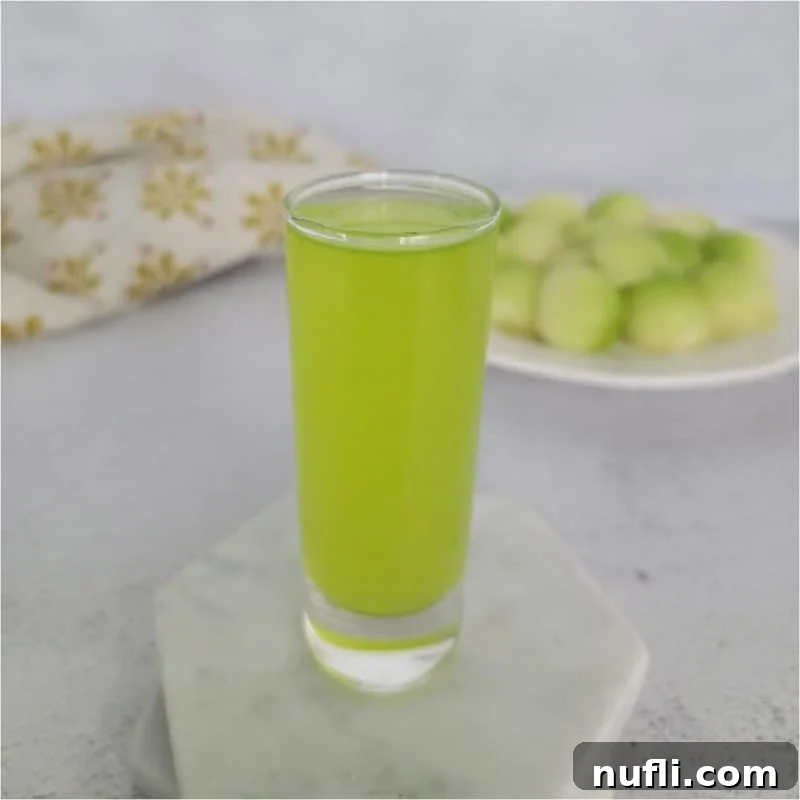 Tropical Pineapple Cocktails Made Easy 3 Melon Ball Shot on a white coaster next to a plate of melon