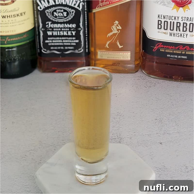 Tropical Pineapple Cocktails Made Easy 24 4 Horsemen Shot in front of liquor bottles