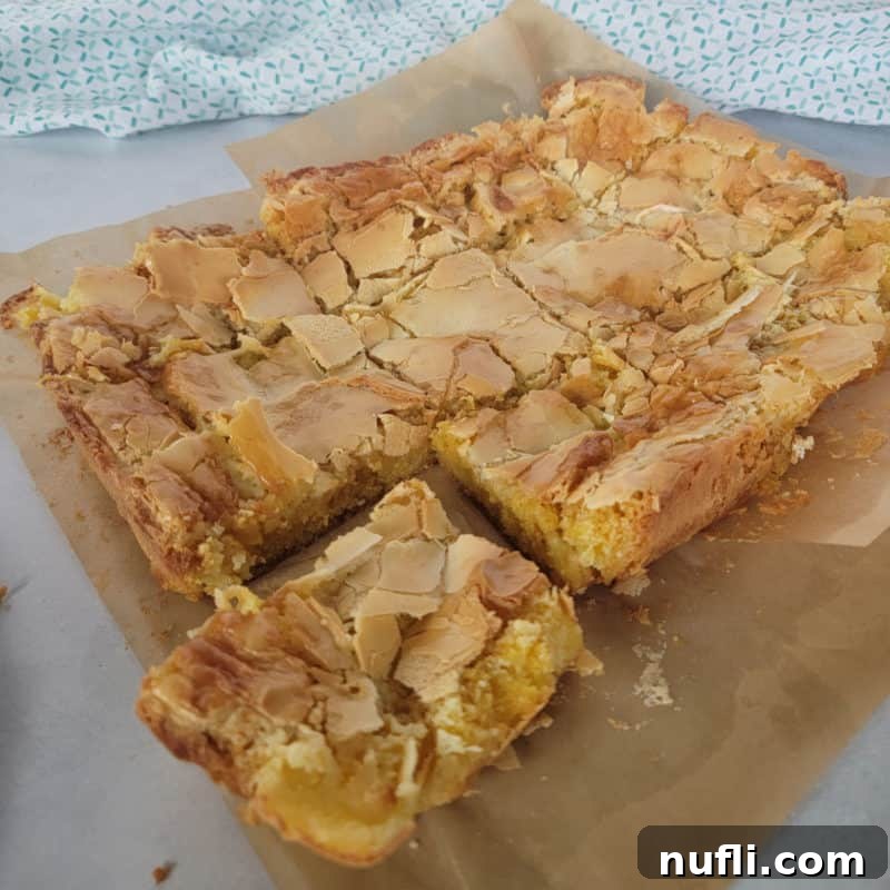 Ooey Gooey Butter Cake recipe on parchment paper with a cloth napkin