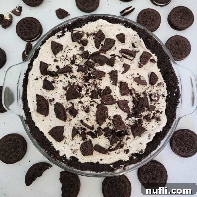 No bake Oreo cheesecake in a glass dish surrounded by Oreo Cookies