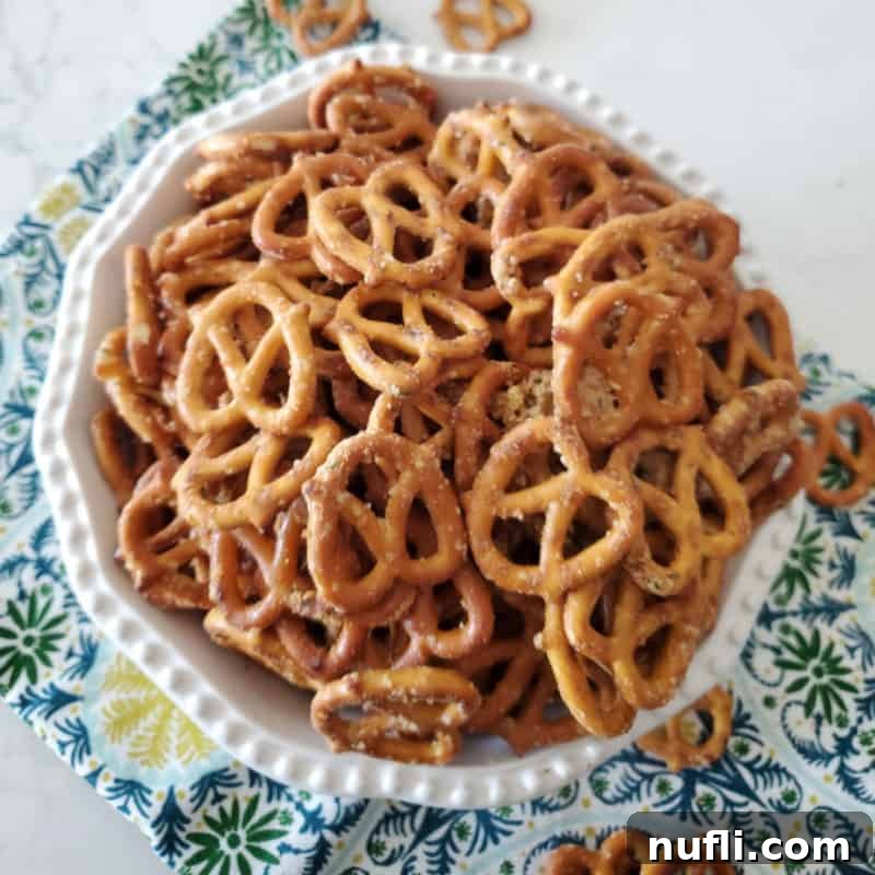 A generous pile of Ranch pretzels, seasoned to perfection and served in a white bowl, resting on a soft cloth napkin, highlighting their irresistible crunch.