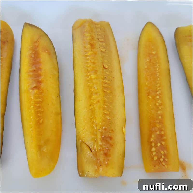 Taco pickle spears, vibrantly seasoned and arranged neatly on a white platter, ready to be enjoyed as a unique and flavorful snack.