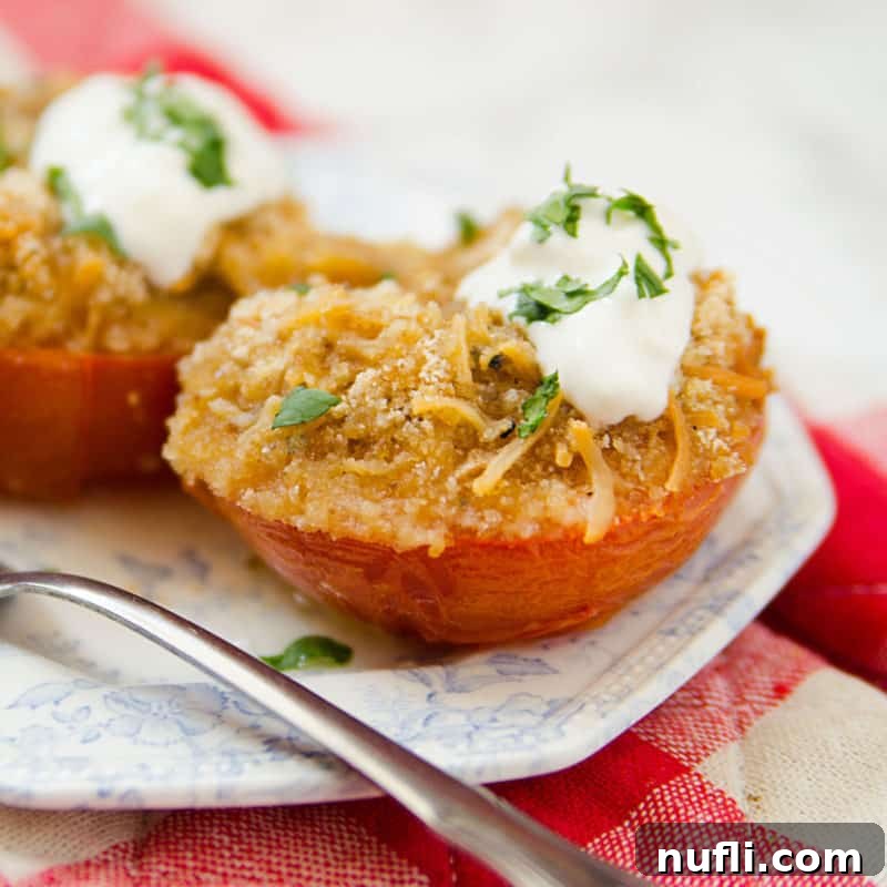 Stuffed tomatoes with cheese and sour cream on a white and blue plate