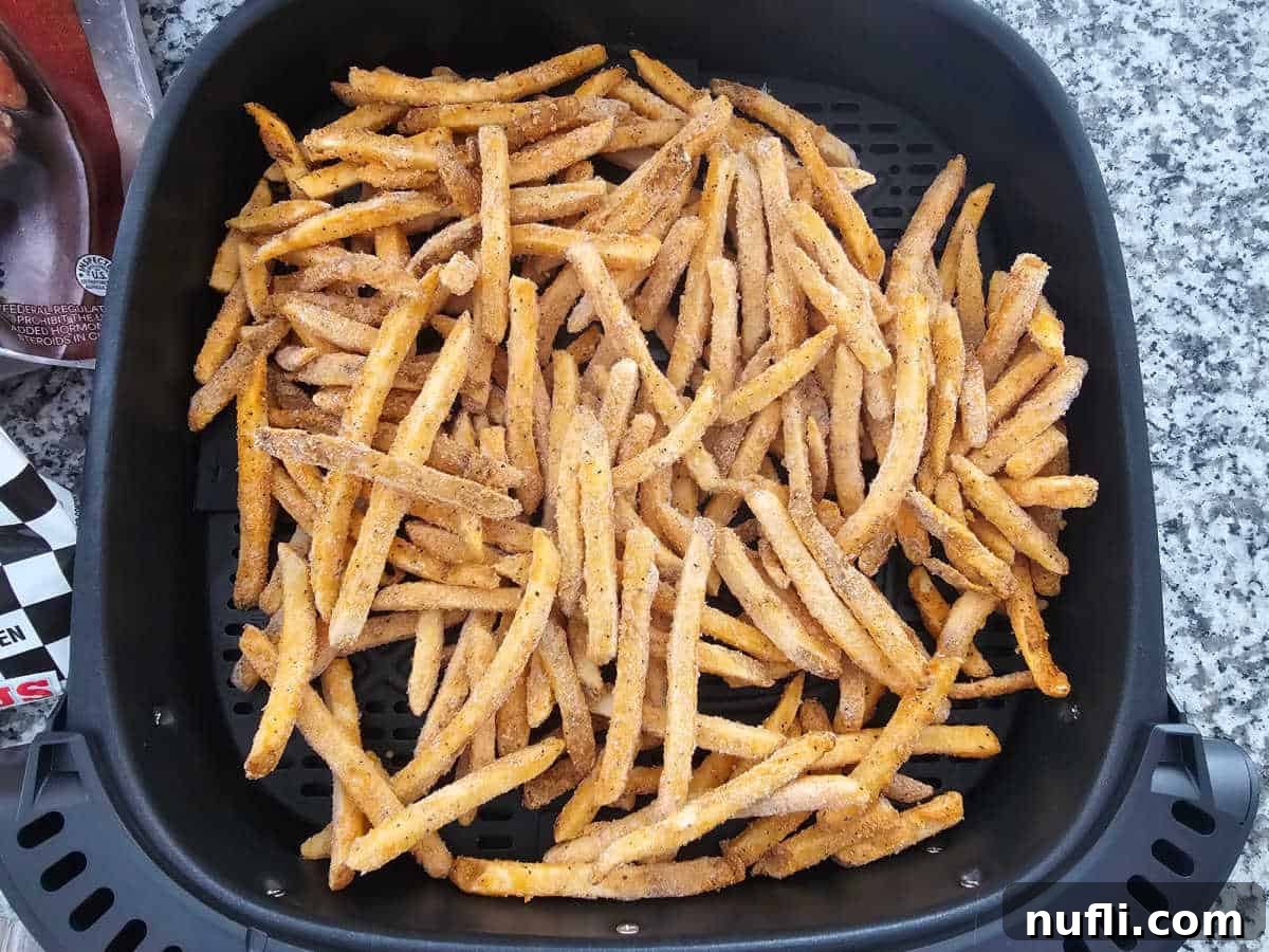 Frozen checkers french fries in an air fryer basket