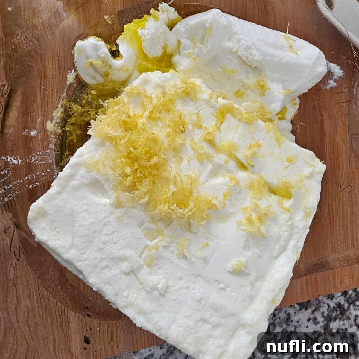 feta, yogurt, lemon zest, and olive oil in a glass bowl