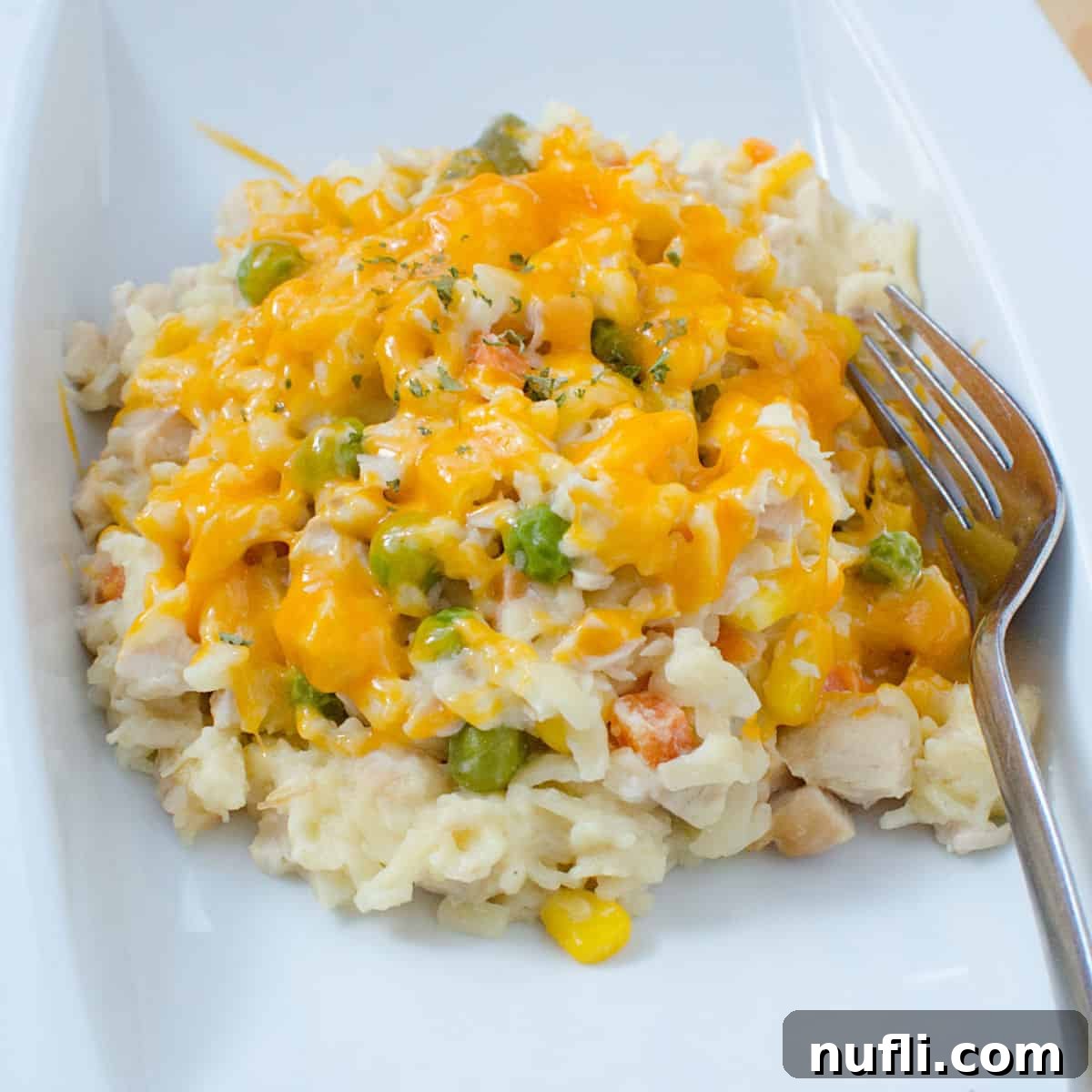 Chicken Orzo Casserole on a white plate with a fork