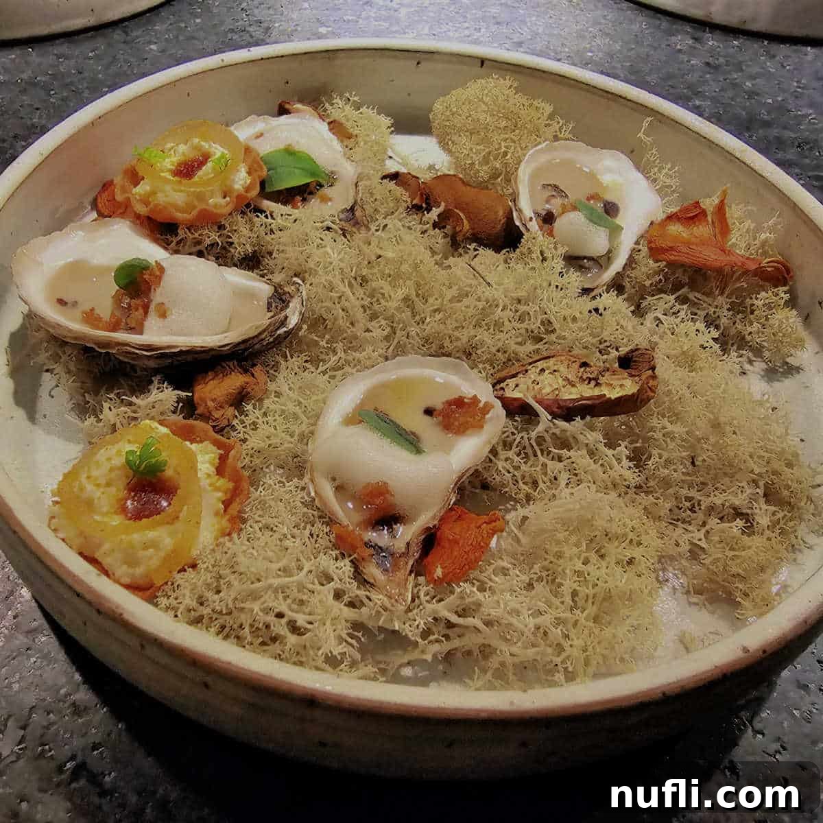 A meticulously arranged tasting plate at Restaurant Tanière³, showcasing delicate and artfully presented culinary creations