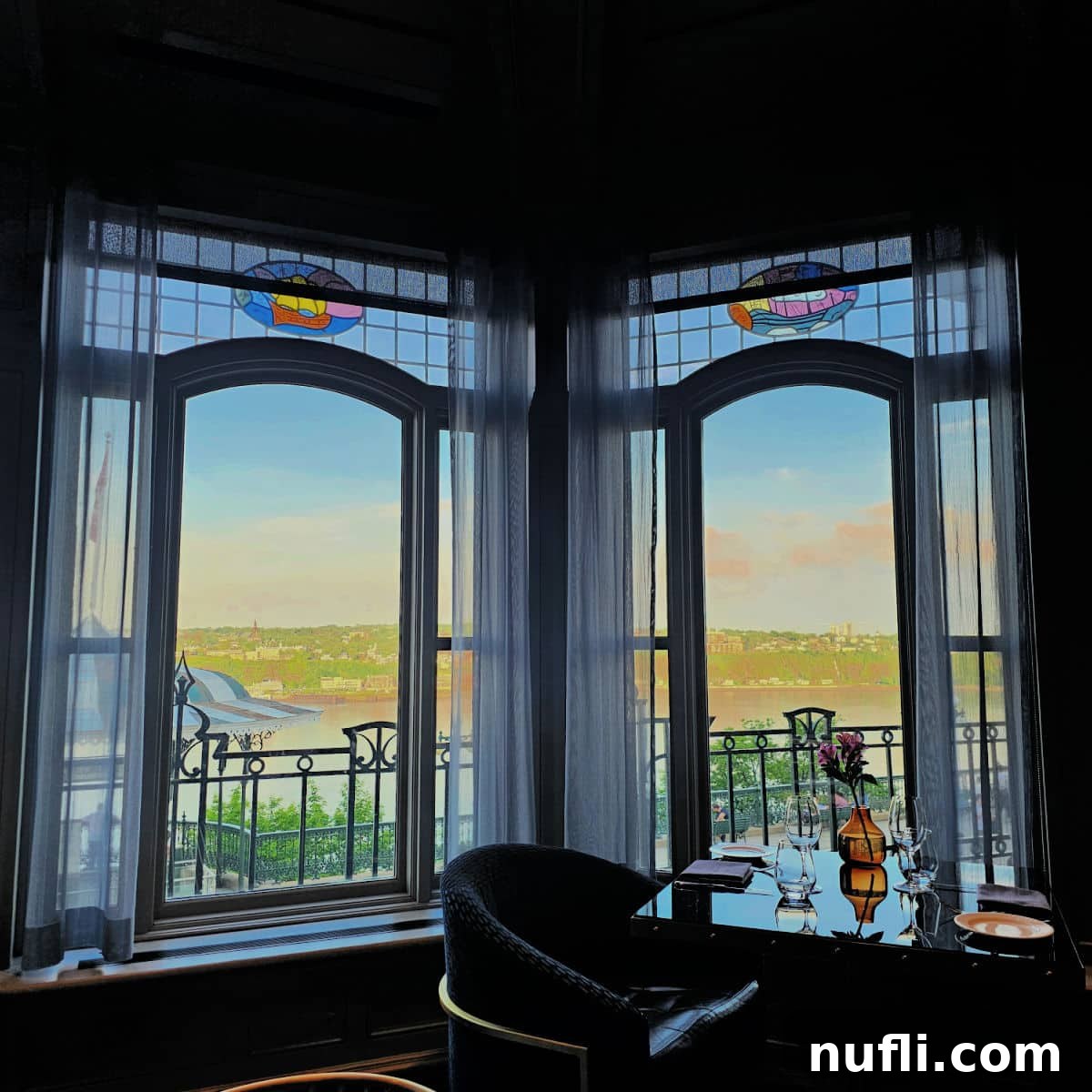 A stunning view looking out from the windows of Bistro Le Sam, offering a panoramic vista of the majestic Saint Lawrence River
