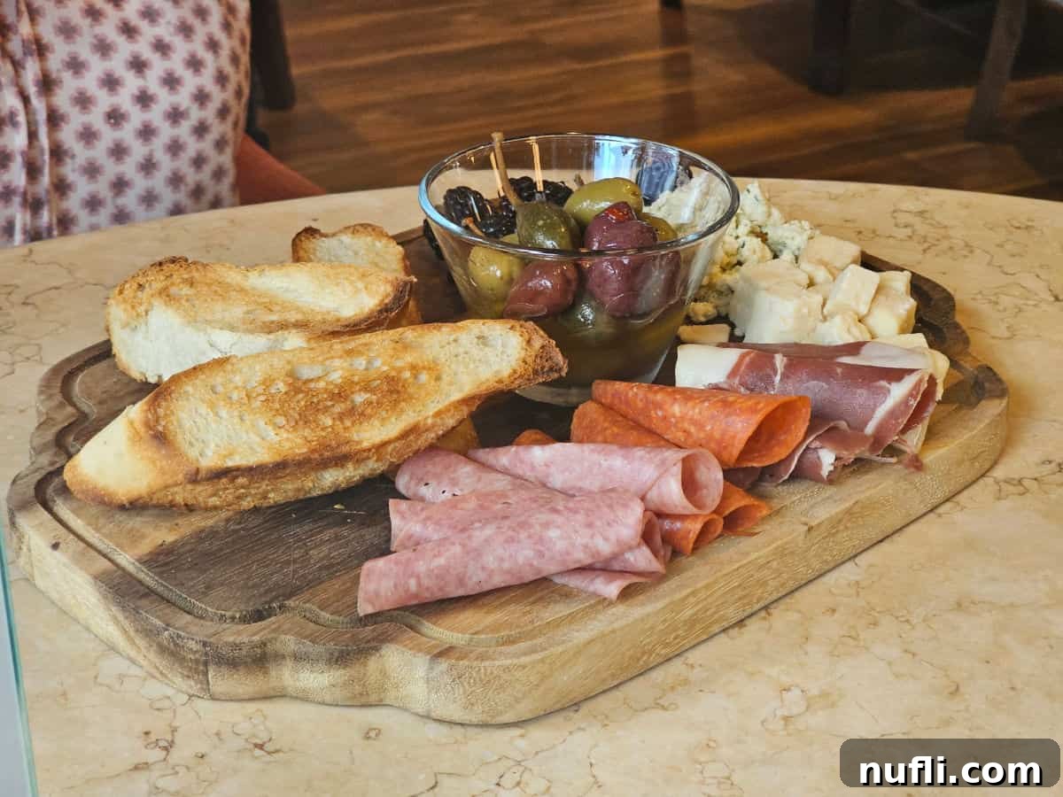 Charcuterie board with meat, cheese and bread