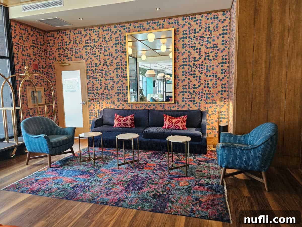 colorful lobby sitting area with blue couch, blue chairs, and brightly colored wallpaper