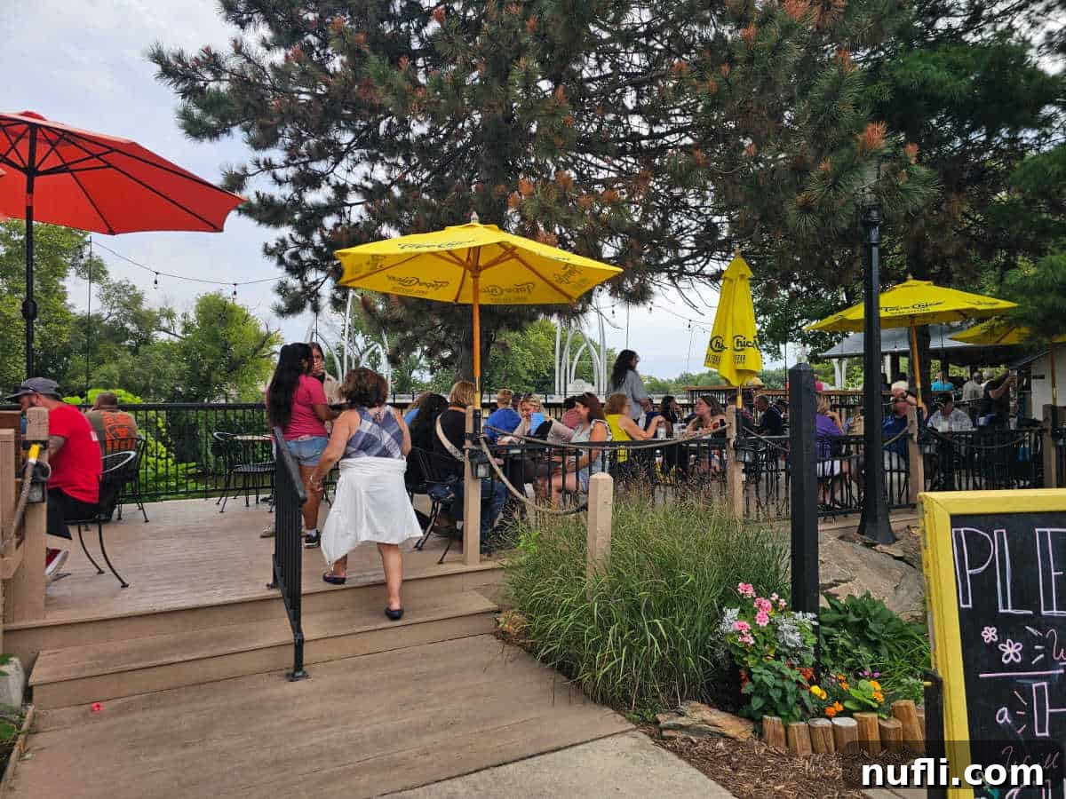 The Deck restaurant with yellow and red umbrellas over tables with people sitting for lunch