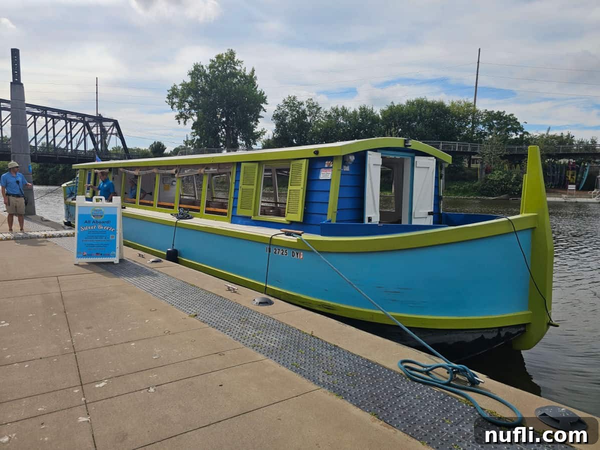 blue and green canal boat on the side of the river