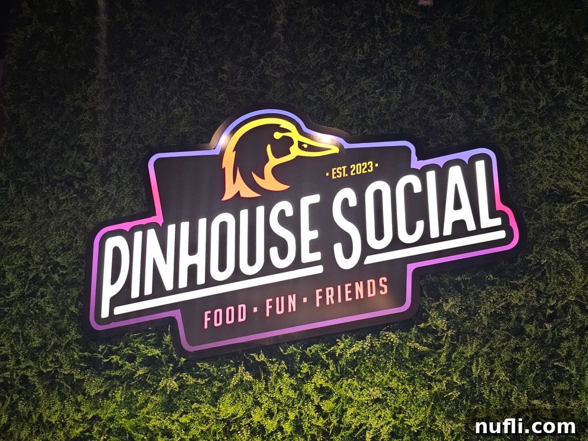 Pinhouse Social logo sign on a green background