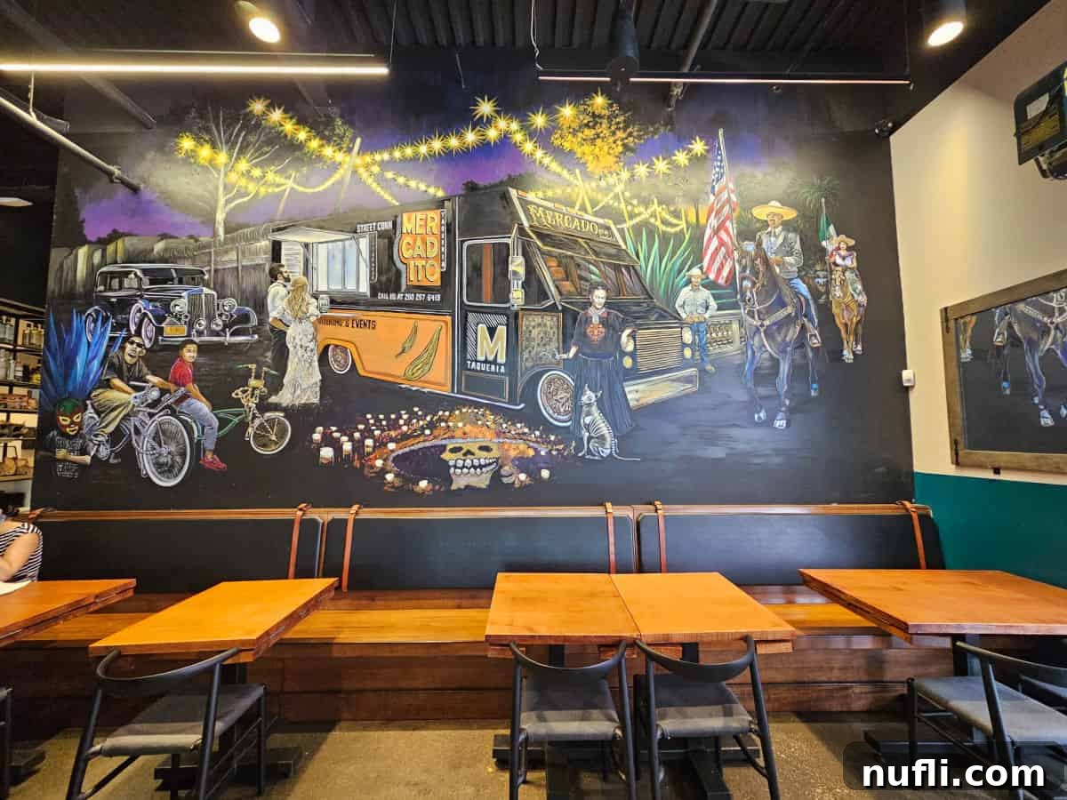 mural with figures next to the Mercado Food Truck over tables and a long bench