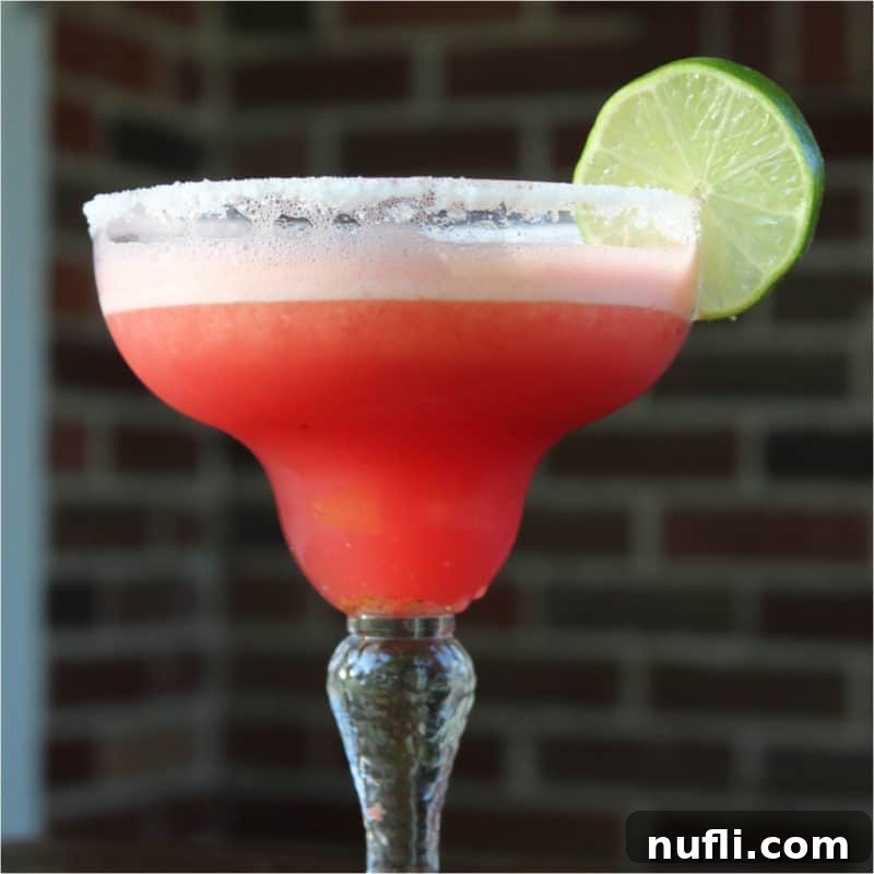 Delicious Tequila Drinks Made Easy 6 Watermelon Margarita served in a classic margarita glass with a lime wheel, highlighting its vibrant color and freshness