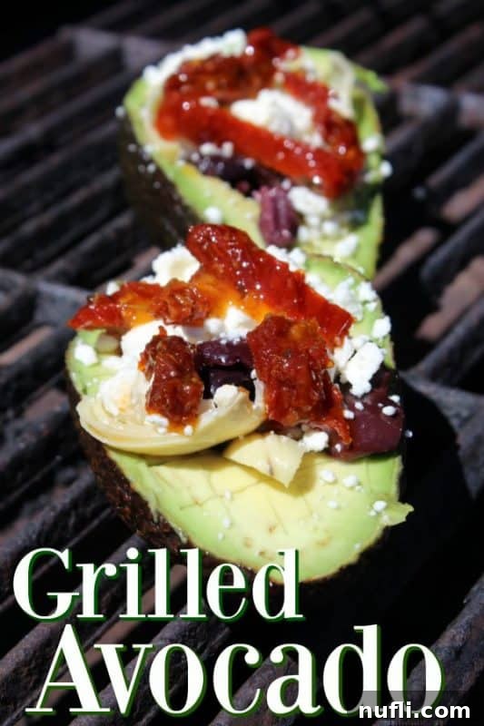 Grilled avocados topped with sun-dried tomatoes, feta cheese, and kalamata olives