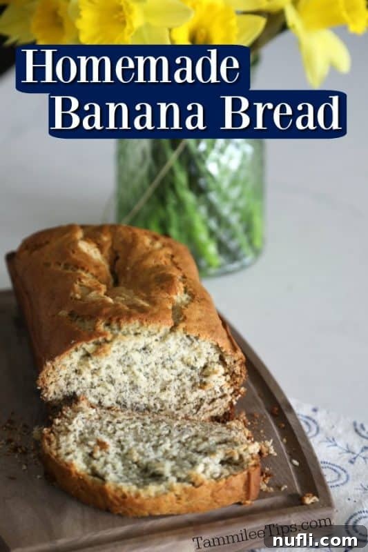 Simple Homemade Banana Bread Bliss 2 Golden brown homemade banana bread loaf, sliced to reveal moist interior, set on a wooden cutting board with fresh daffodils in the background.