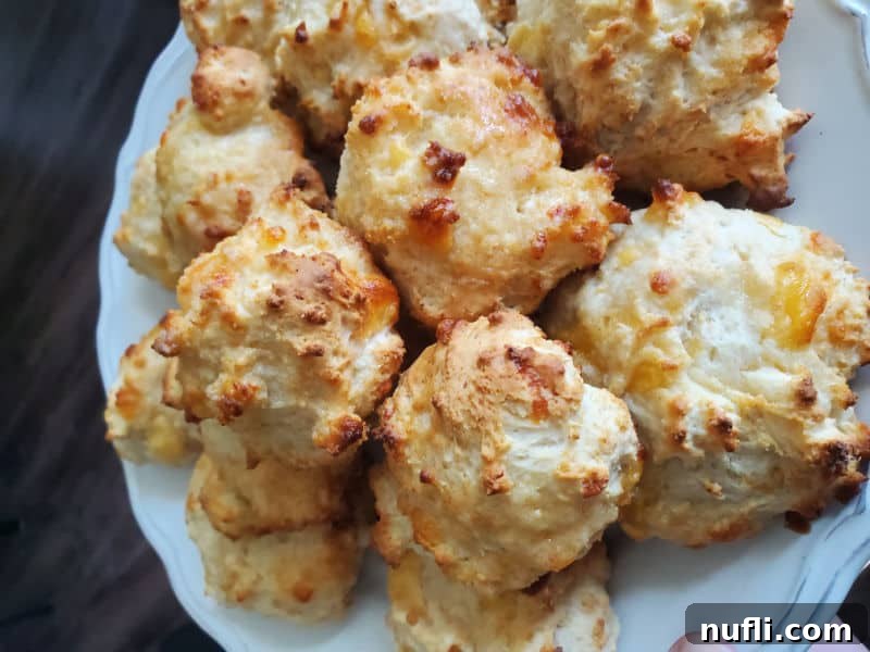 Cheddar Biscuits piled on a white plate