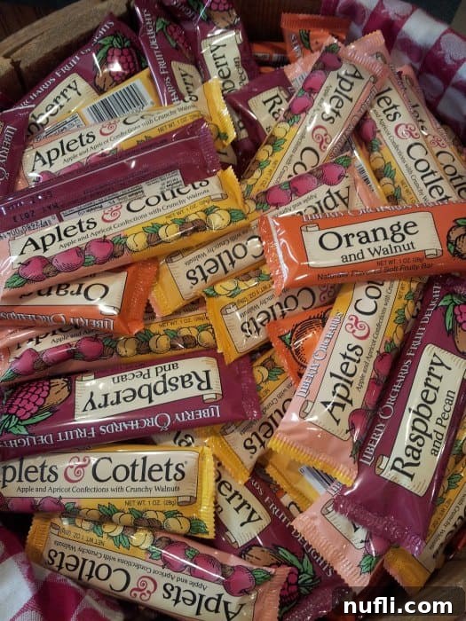 A basket filled with various flavored Aplets & Cotlets candy bars, showcasing the diverse range of fruit delights.