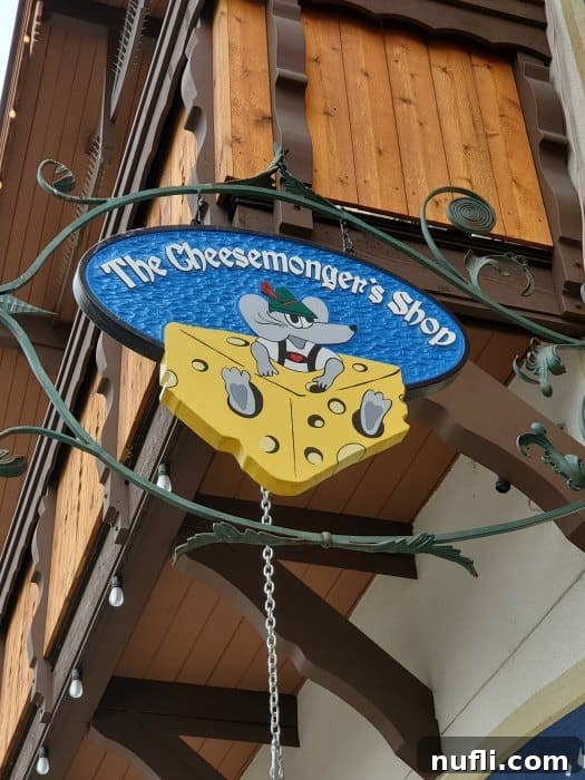 Sign for The Cheesemonger Shop, inviting visitors to explore artisanal cheeses.