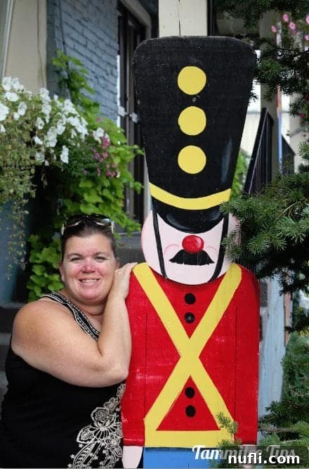 Tammilee posing next to a cheerful toy soldier cutout in Leavenworth.
