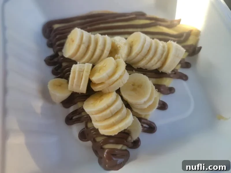 Delicious crepe with Nutella and fresh bananas, a perfect sweet treat.