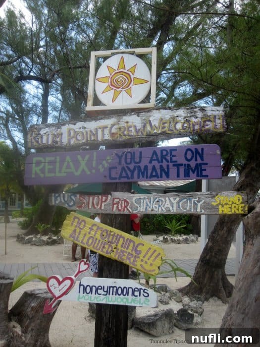 Welcome sign at Rum Point with directions to various places around the world