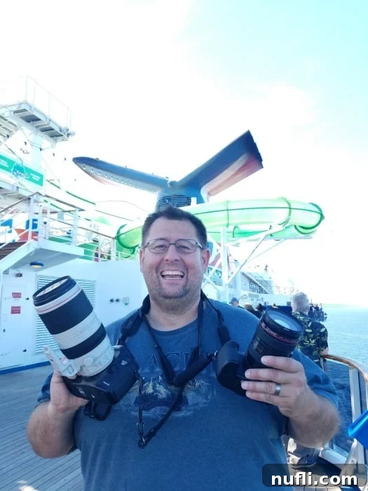 John holding two cameras on a carnival cruise ship 