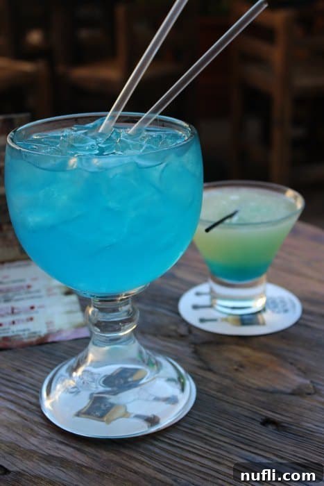 Blue cocktail with two straws