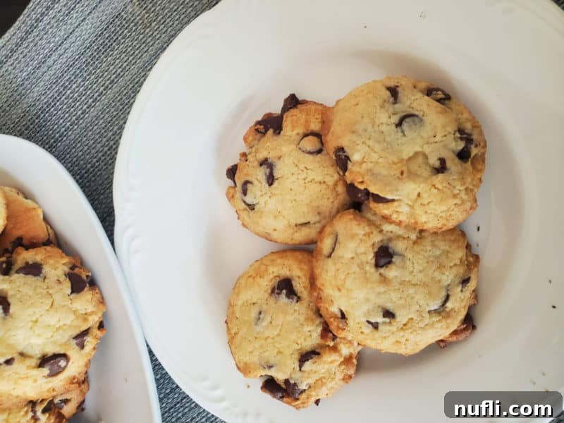 Easy Cake Mix Chocolate Chip Cookies 6 Freshly baked chocolate chip cake mix cookies displayed artfully on a white ceramic plate, ready to be enjoyed.