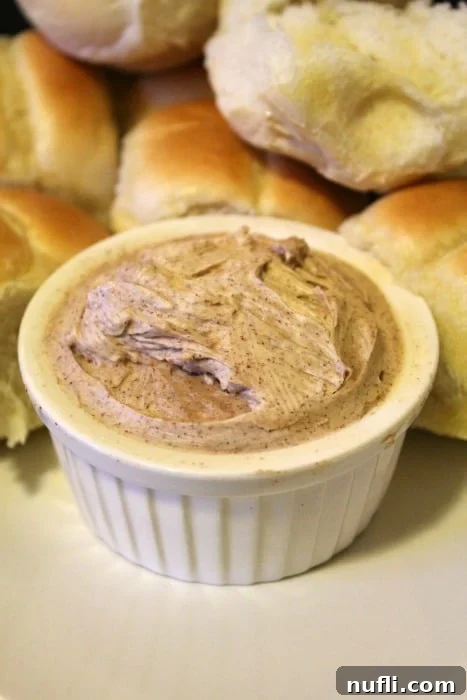 Texas Roadhouse Butter in a white bowl next to rolls
