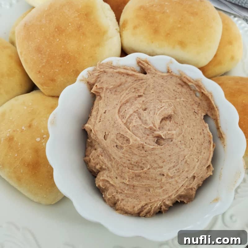 Texas Roadhouse Butter in a white bowl next to rolls