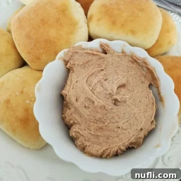 Texas Roadhouse Butter in a white bowl next to rolls