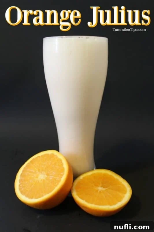 Orange Julius in a tall glass with fresh orange slices