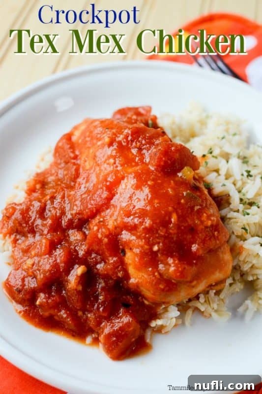 Zesty Slow Cooker Tex-Mex Chicken 2 Delicious Crockpot Tex-Mex Chicken served over fluffy white rice on a clean white plate with a fork, ready to be enjoyed.