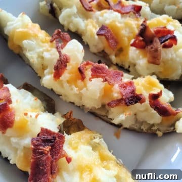 Cheese and bacon potato skins on a white platter