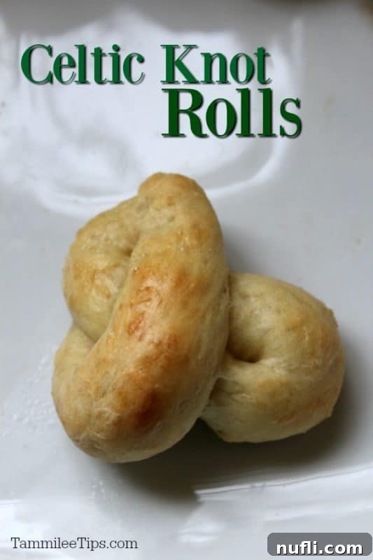 Weaving Celtic Knot Rolls 2 Freshly baked Celtic knot rolls on a white plate, with one roll stacked on top.