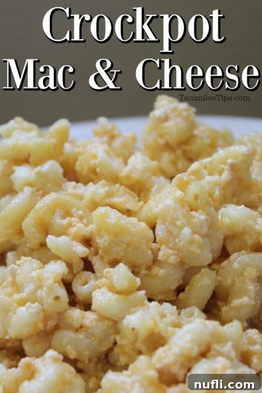 A generous serving of creamy homemade Slow Cooker Mac and Cheese in a white bowl, garnished with a sprig of parsley, showcasing its rich texture.