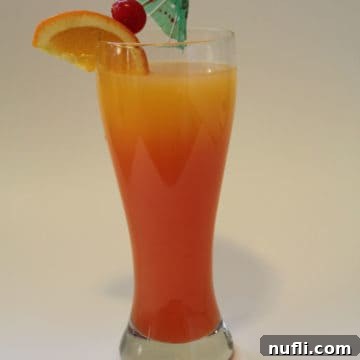 Sunrise Tequila Cocktail Recipe 3 Tequila Sunrise Cocktail in a tall glass with tropical umbrella