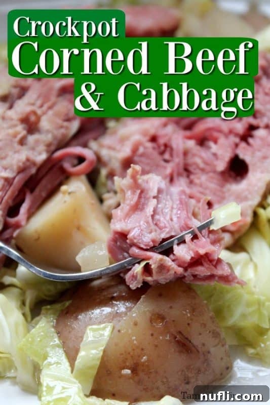 Crockpot Corned Beef and Cabbage text written at the top. Silver fork holding a piece of slow cooker corned beef resting on a sliced potato and cabbage
