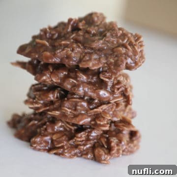 Stacked Chocolate Peanut Butter No-Bake Cookies on a white plate
