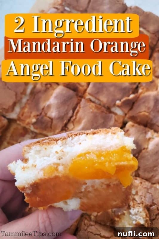 A slice of 2-Ingredient Mandarin Orange Angel Food Cake being held, highlighting its light texture and golden-orange hue.