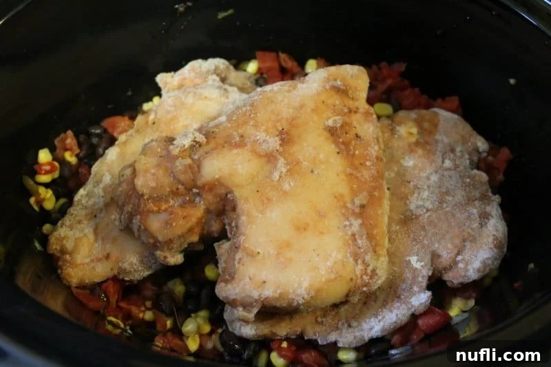chicken on southwest vegetable mix in slow cooker