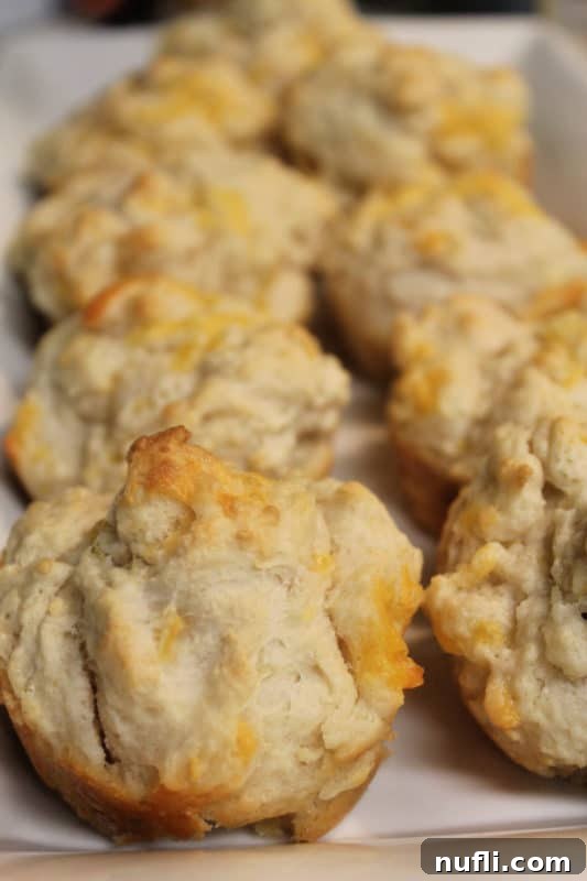 Garlic cheese muffins on a white platter