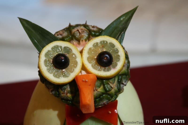 Close-up of a fruit animal owl's face, showcasing a carrot nose and lemon eyes, crafted with incredible detail.