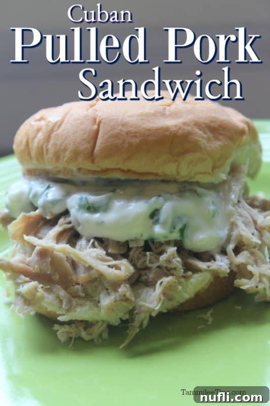 Slow Cooked Cuban Pork Sandwiches with Zesty Cilantro Mayo 2 Cuban Pulled Pork Sandwich over a green plate with a pulled pork sandwich