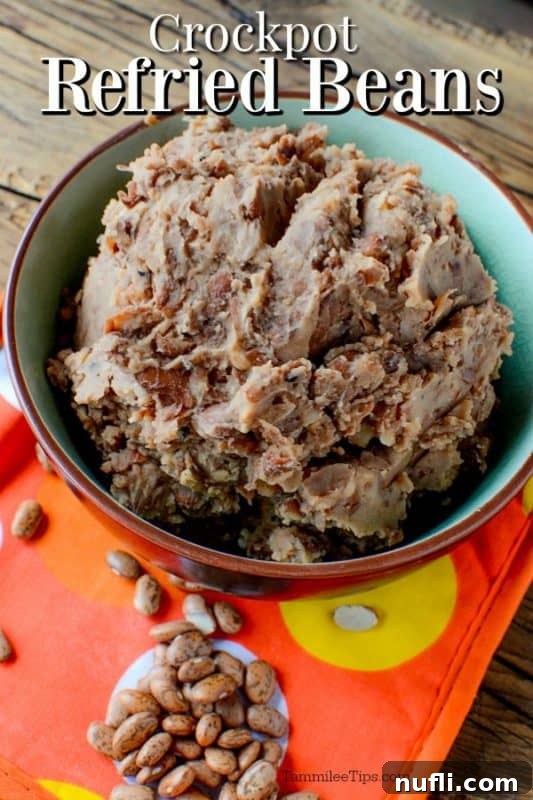 Crockpot refried beans over a bowl of beans 